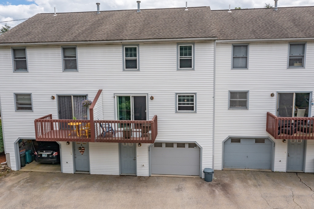 30 Lochmere Lane, Unit 30 Nashua, NH 03063 - Photo 19 of 19 a view of a house with a barbeque and wooden fence
