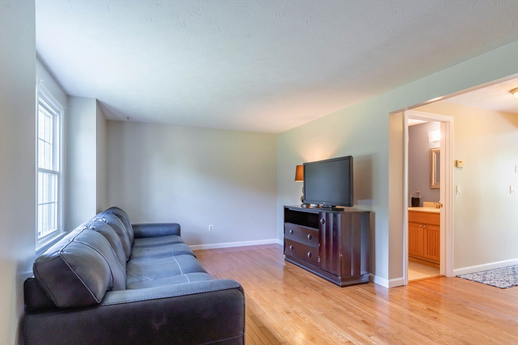 30 Lochmere Lane, Unit 30 Nashua, NH 03063 - Photo 3 of 19 a living room with furniture and a flat screen tv