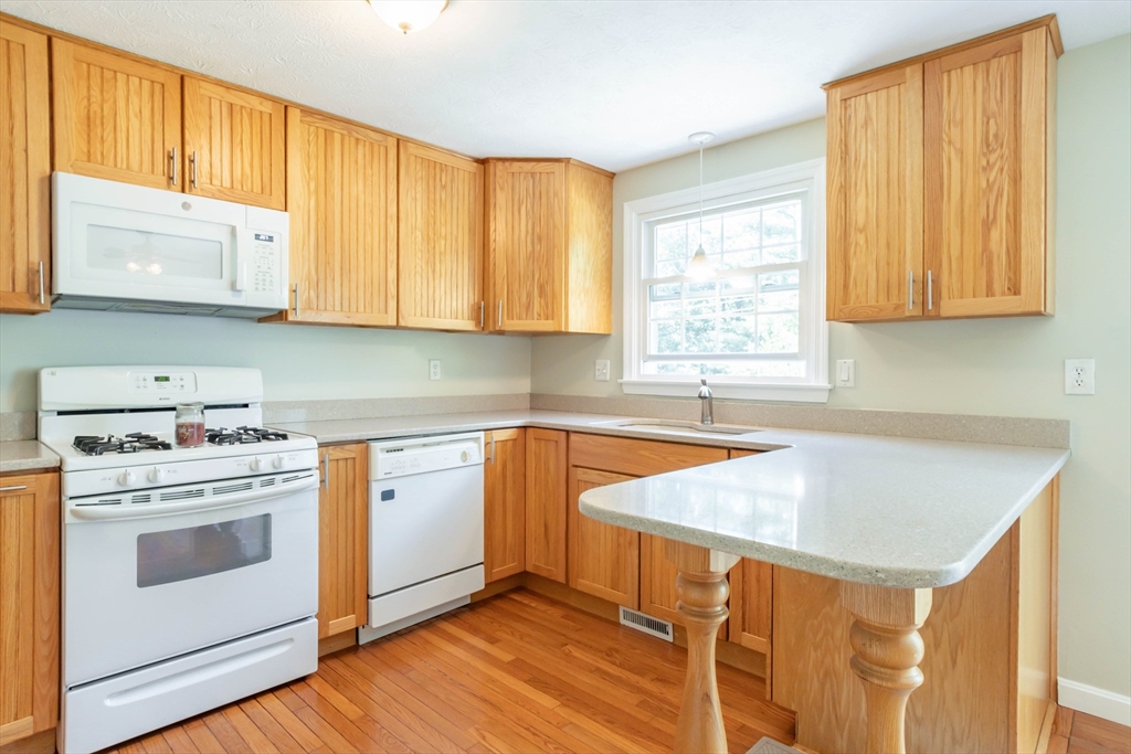 30 Lochmere Lane, Unit 30 Nashua, NH 03063 - Photo 9 of 19 a kitchen with a sink cabinets and window