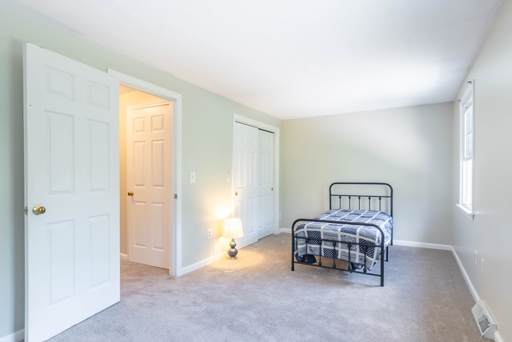 30 Lochmere Lane, Unit 30 Nashua, NH 03063 - Photo 10 of 19 a room with furniture a baby crib and a window