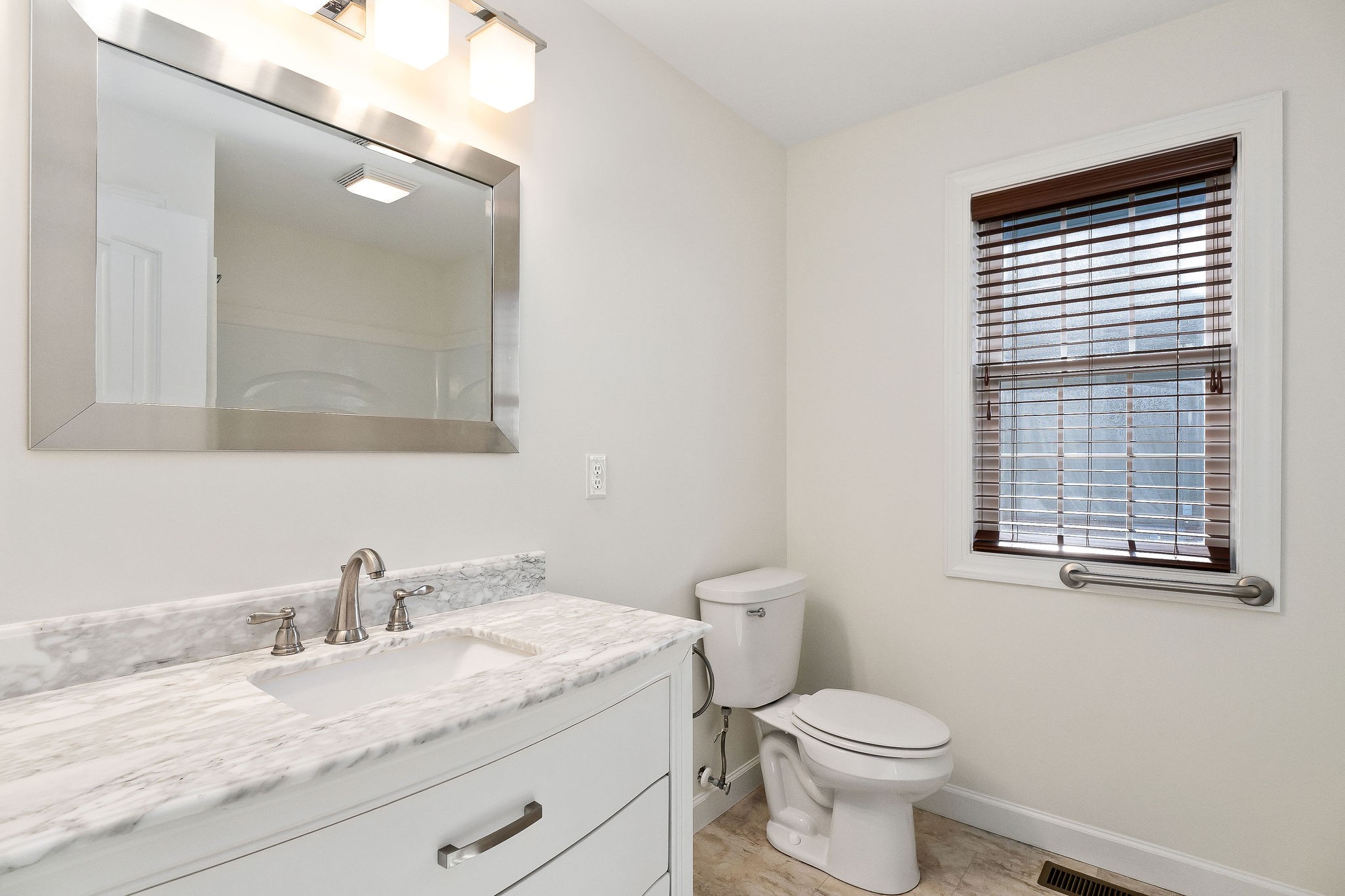 7060 Ditty Road Cookeville, TN 38506 - Photo 11 of 35 a bathroom with a granite countertop toilet sink and mirror