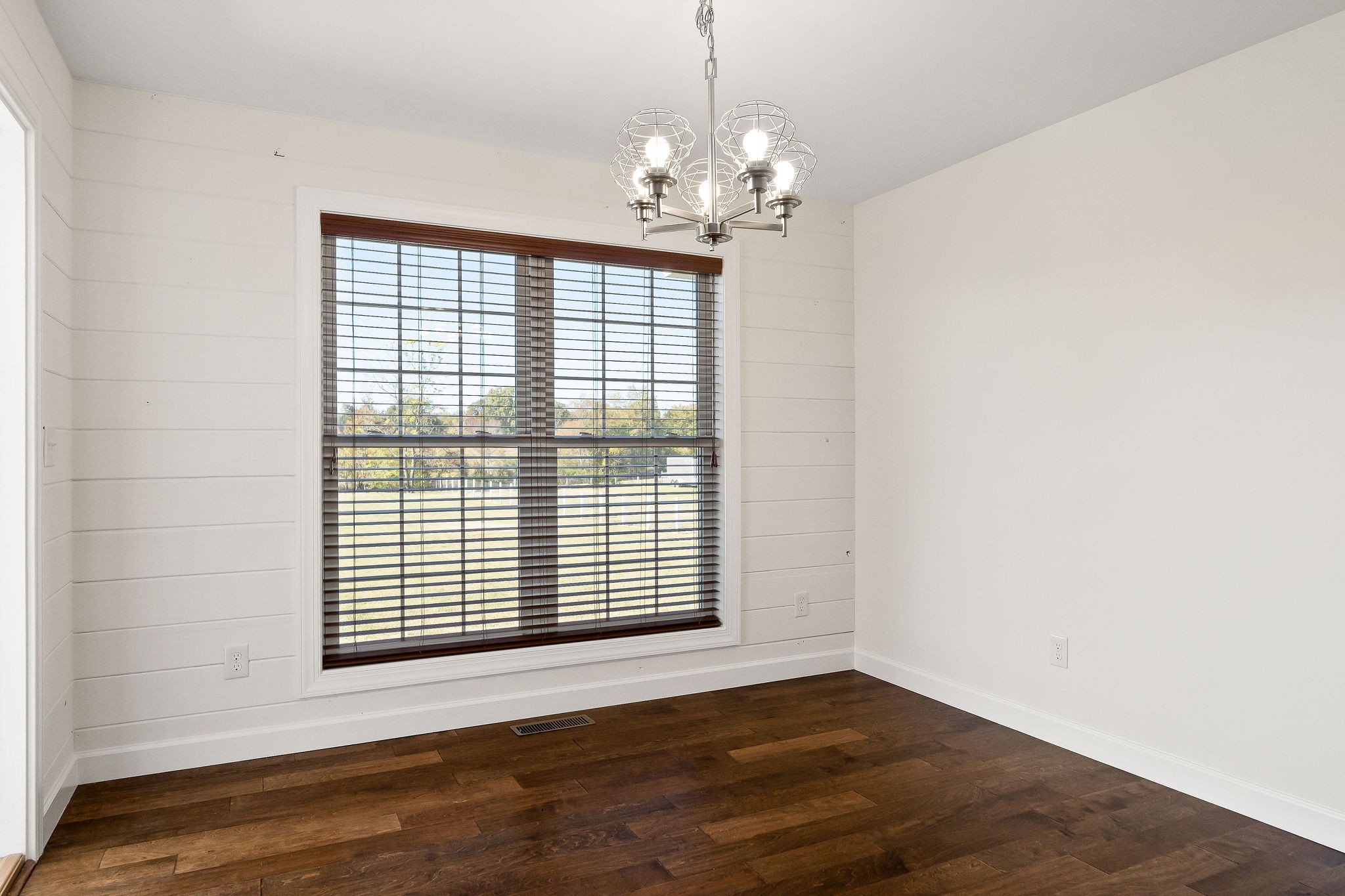 7060 Ditty Road Cookeville, TN 38506 - Photo 21 of 35 a view of an empty room with wooden floor and a window