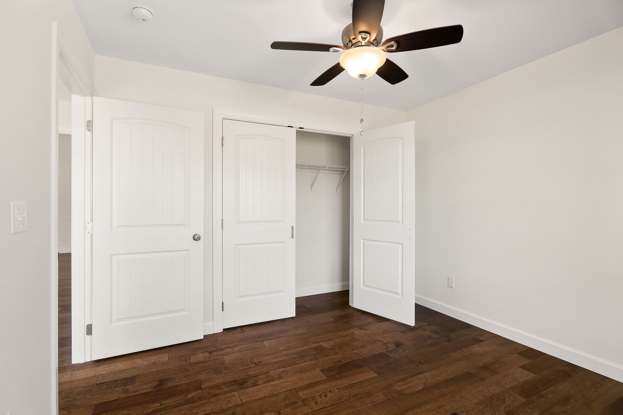 7060 Ditty Road Cookeville, TN 38506 - Photo 8 of 35 an empty room with wooden floor ceiling fan and windows