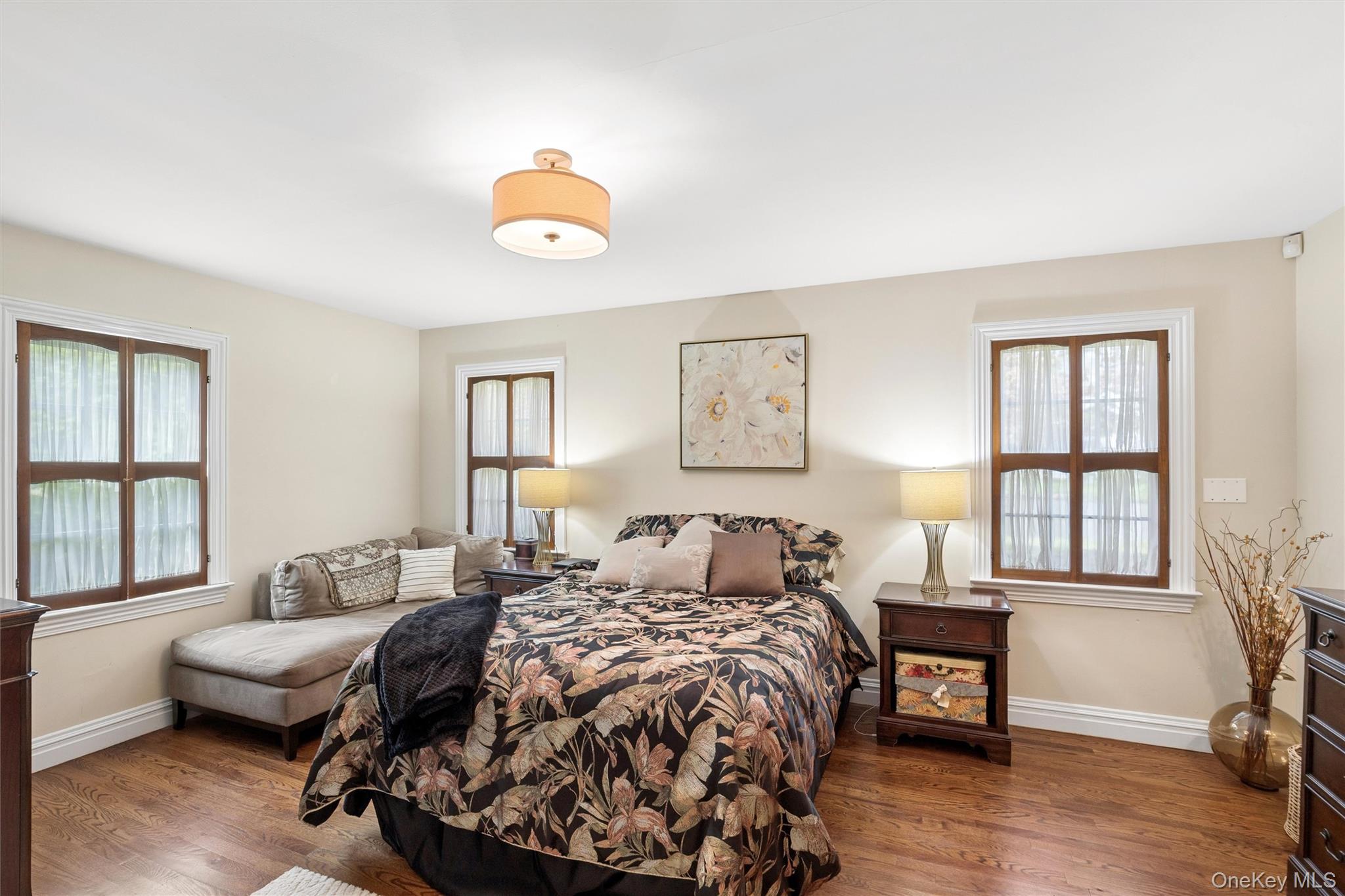 50 Belton Road Babylon, NY 11702 - Photo 21 of 34 Another view of the master bedroom with 3 windows letting ample light in and plenty of cross ventilation plus gleaming hardwood floors.