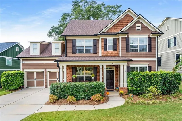 a front view of a house with a yard and porch