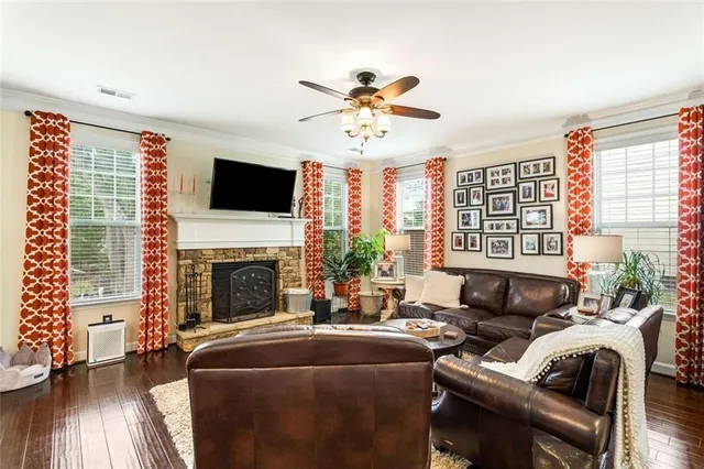 a living room with furniture a fireplace and a flat screen tv