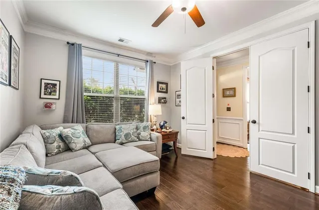 a living room with furniture and wooden floor