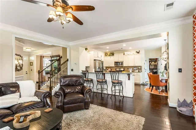 a living room with furniture and wooden floor