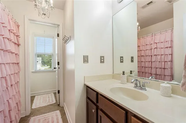 a bathroom with a sink vanity granite and a mirror