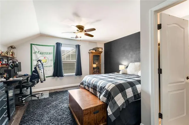 a bedroom with a bed a chandelier and dresser