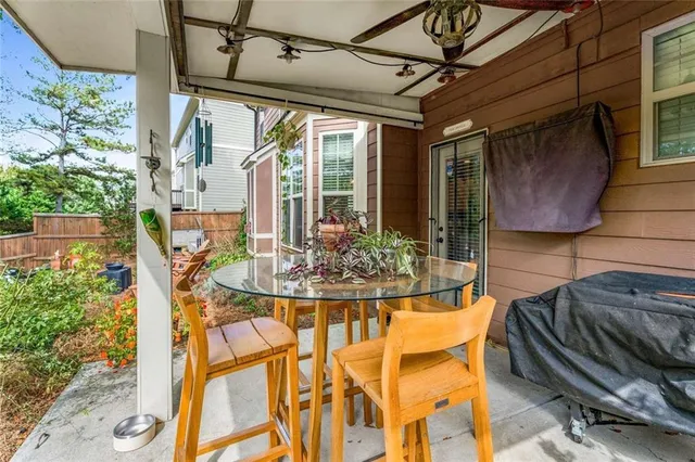 a view of a patio with table and chairs and potted plants