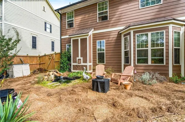 a backyard of a house with outdoor seating
