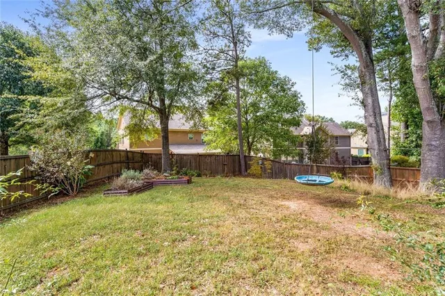 a view of a yard with a house and large trees