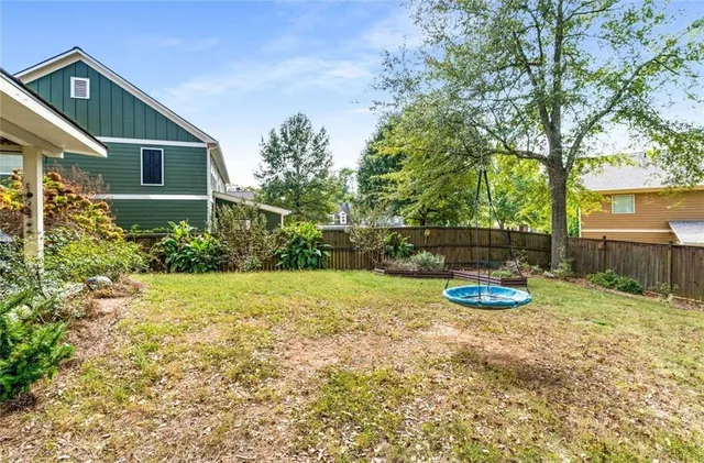 a view of a house with backyard and sitting area