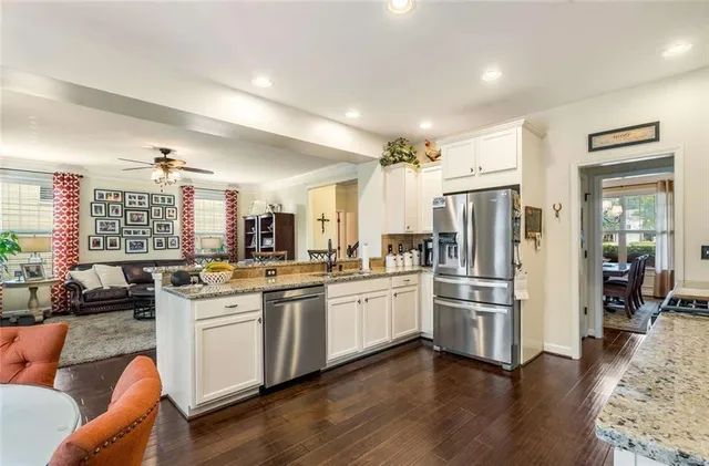 a kitchen with white cabinets and stainless steel appliances