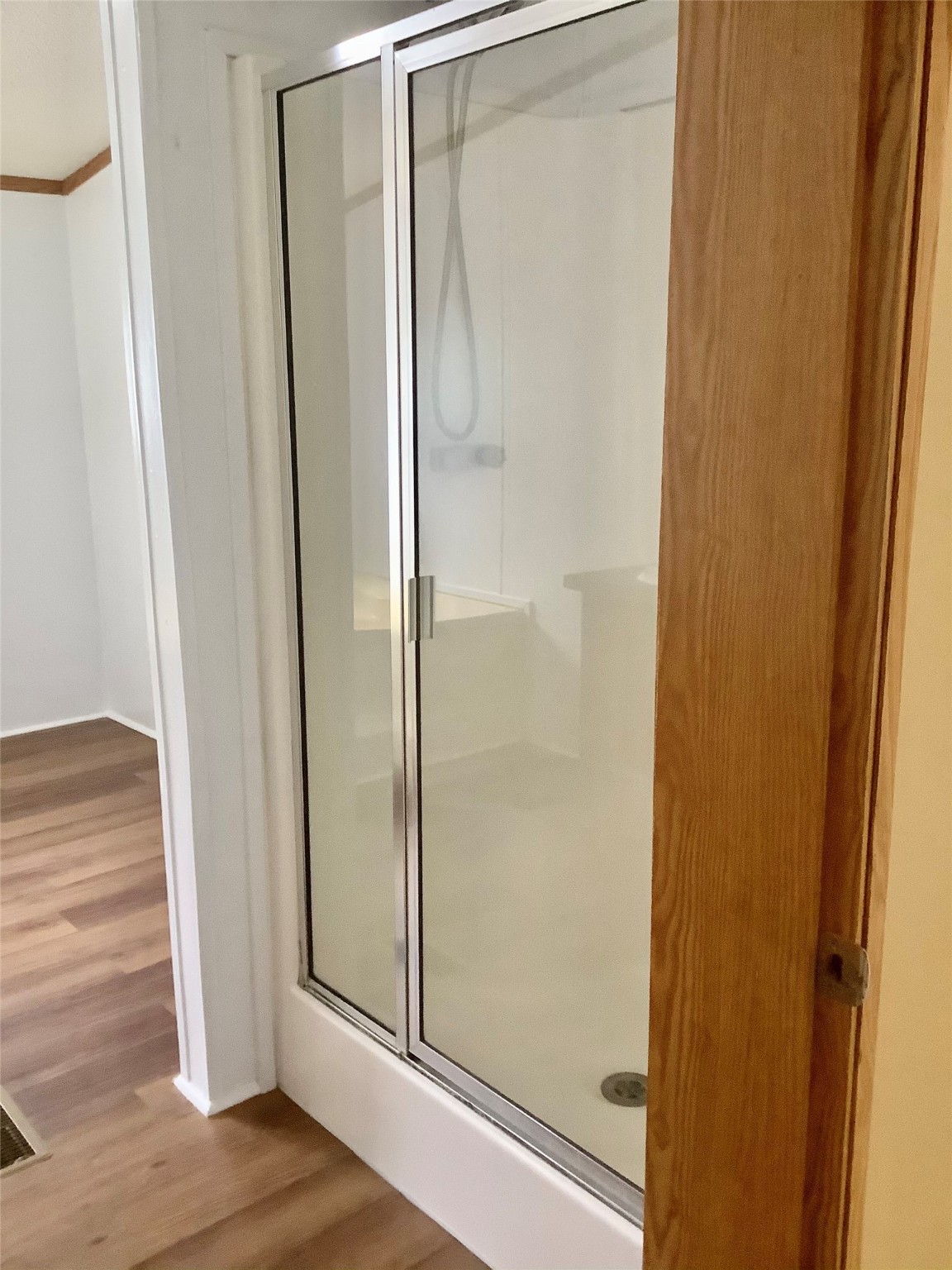 27199 Short Street Splendora, TX 77372 - Photo 13 of 18 a bathroom with a glass shower door