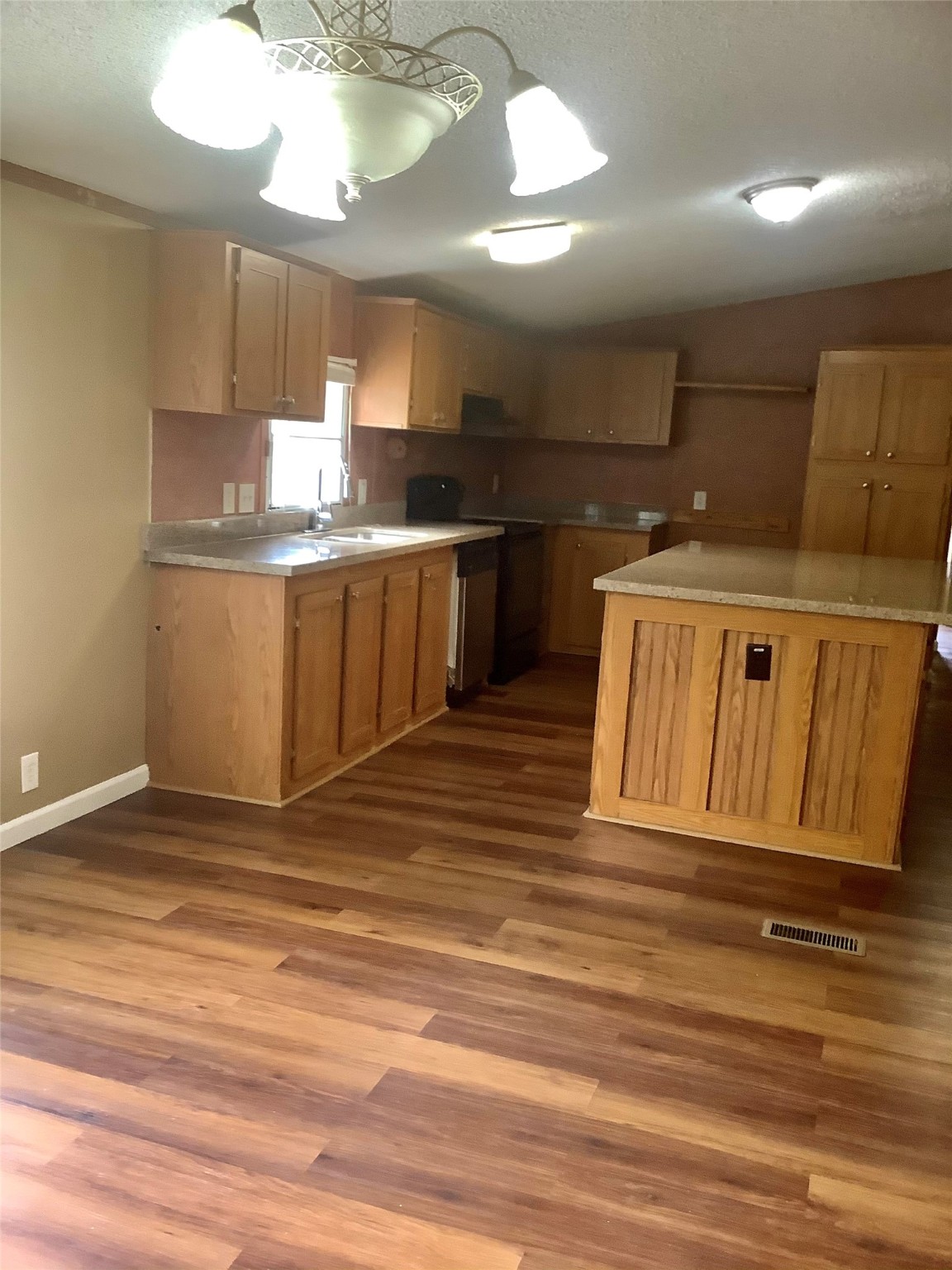 27199 Short Street Splendora, TX 77372 - Photo 3 of 18 a view of kitchen with cabinets and wooden floor