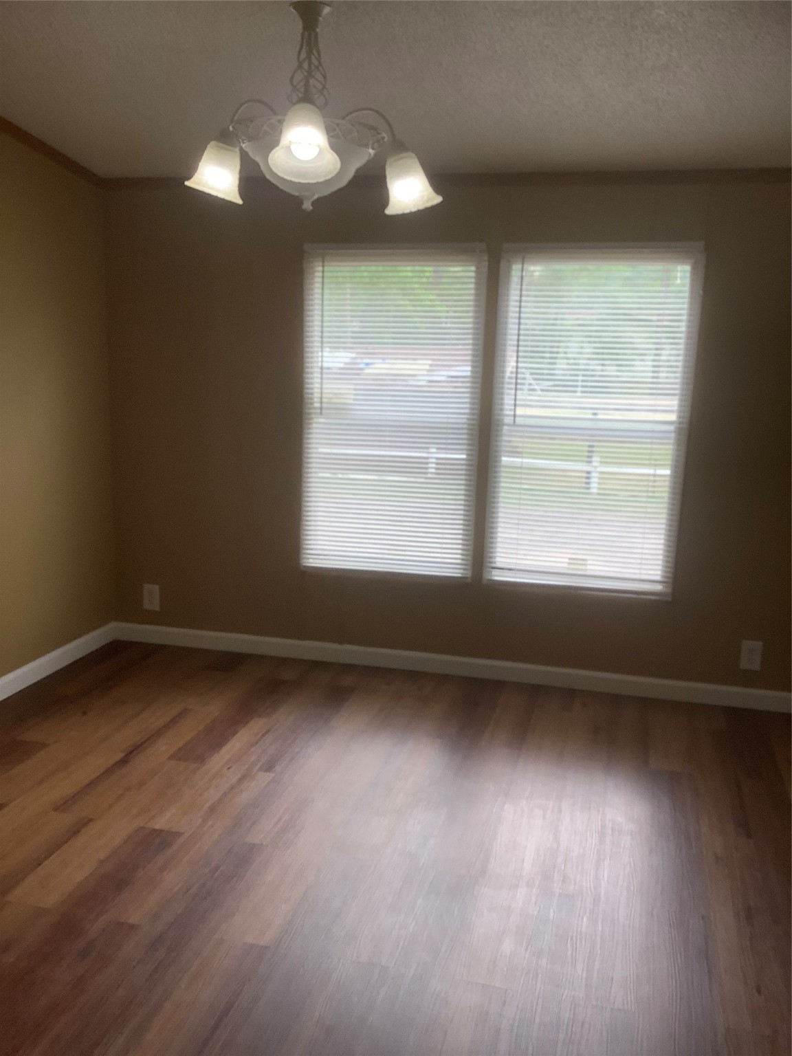 27199 Short Street Splendora, TX 77372 - Photo 5 of 18 a view of an empty room with wooden floor and a window