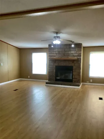 a room with fireplace and a wooden floor