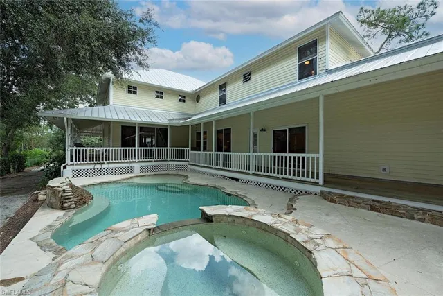 a view of a house with a wooden deck and a large window