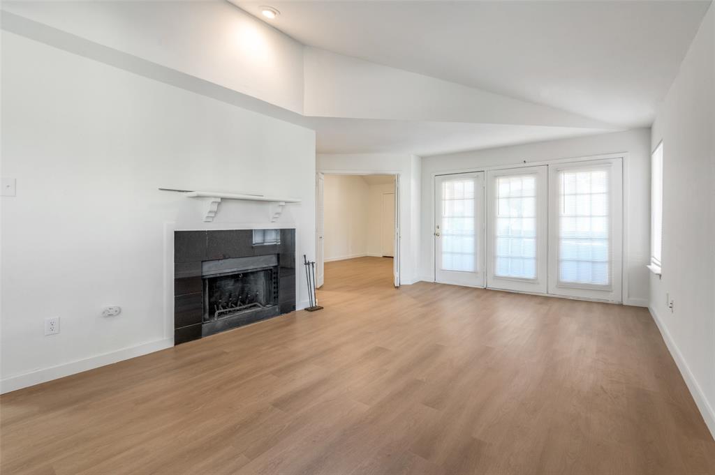 5550 Spring Valley Road, Unit D31 Dallas, TX 75254 - Photo 14 of 20 wooden floor fireplace and windows in a room