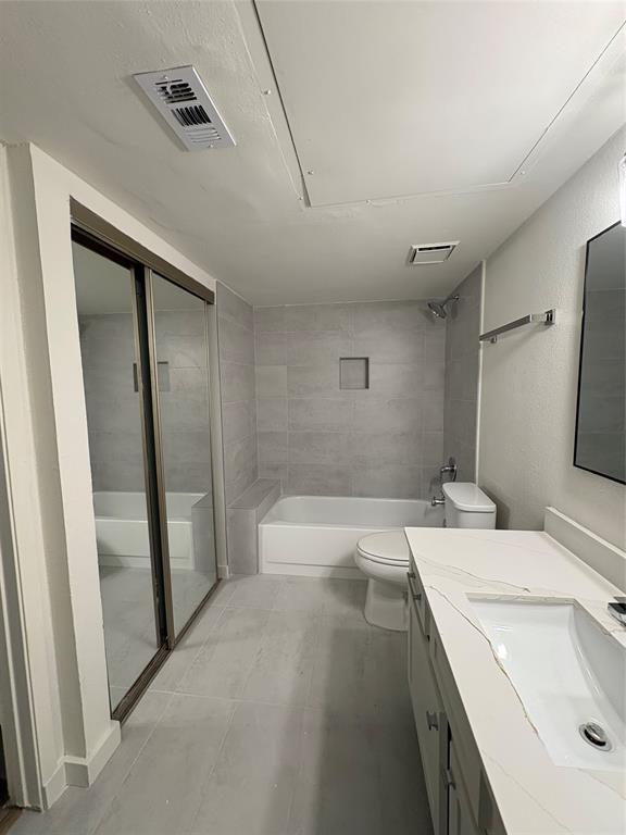 5550 Spring Valley Road, Unit D31 Dallas, TX 75254 - Photo 9 of 20 a bathroom with a sink a toilet and shower