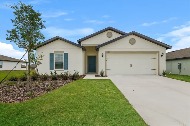 a front view of house with yard and green space