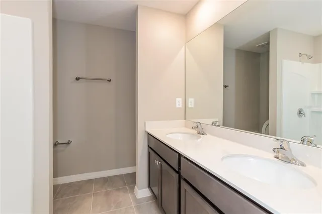 a bathroom with a double vanity sink and a mirror
