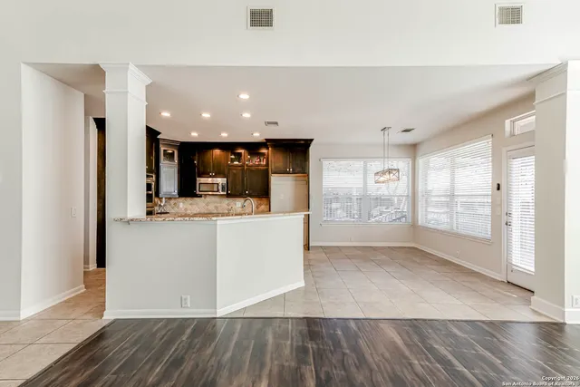 a view of kitchen with furniture and wooden floor