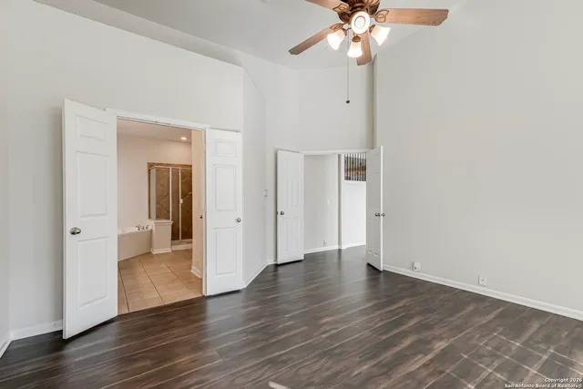 a view of an empty room with wooden floor