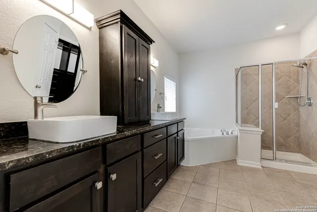 a bathroom with a double vanity sink a toilet and mirror