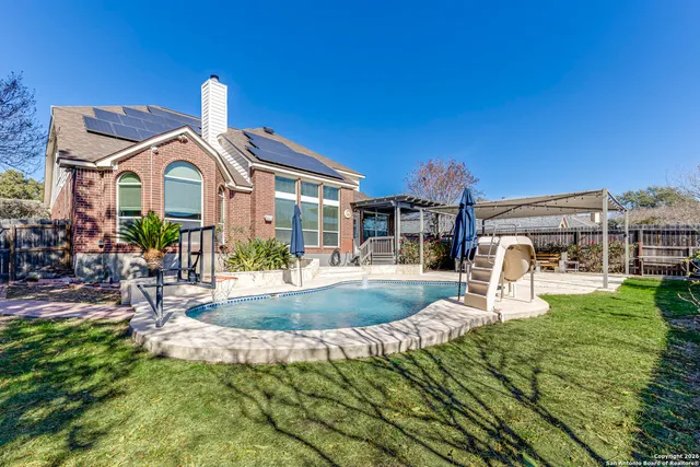 a view of a house with backyard porch and sitting area
