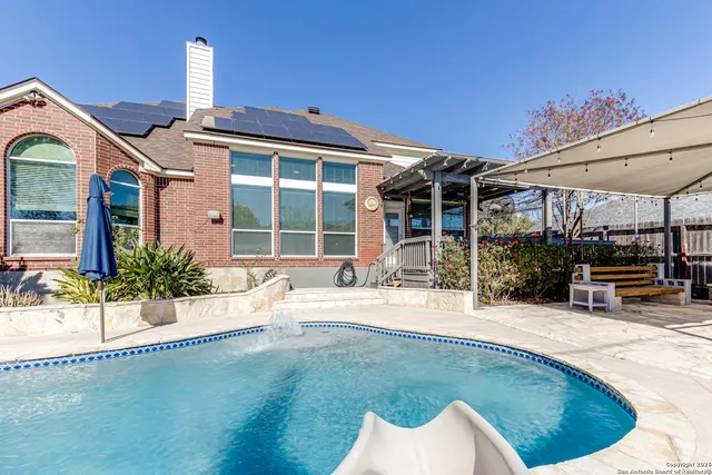a view of a house with swimming pool and porch