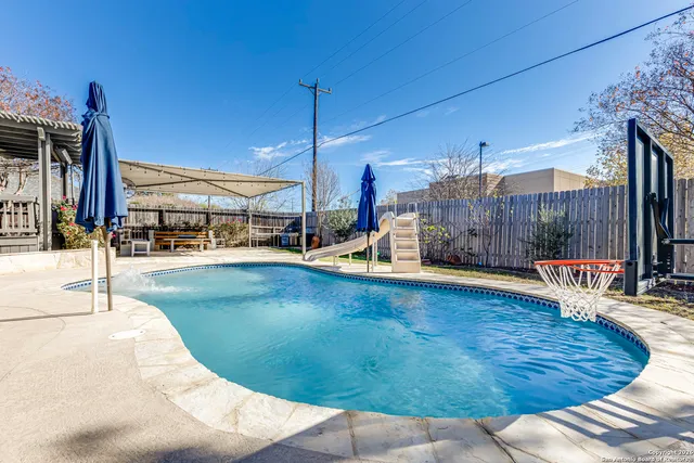 a view of a swimming pool with a patio