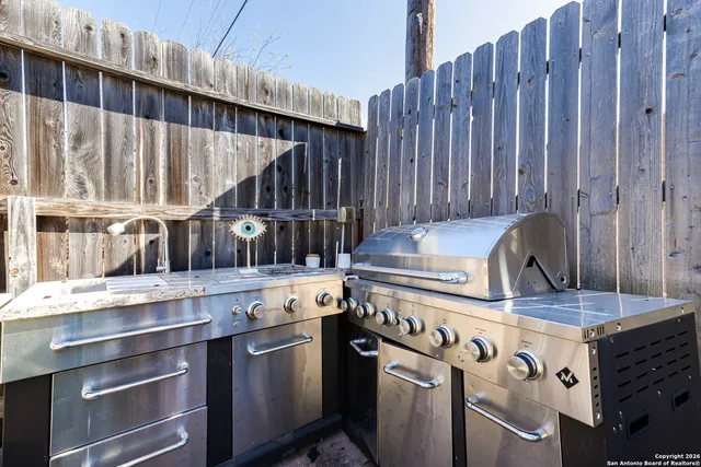 a kitchen with a stove and a wooden cabinets
