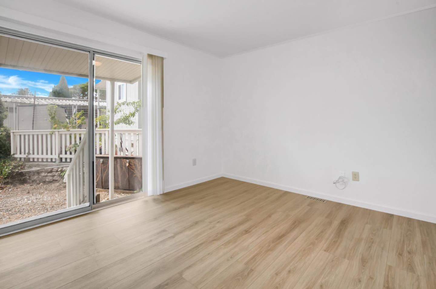4300 Soquel Drive, Unit 15 Soquel, CA 95073 - Photo 11 of 15 an empty room with wooden floor and windows