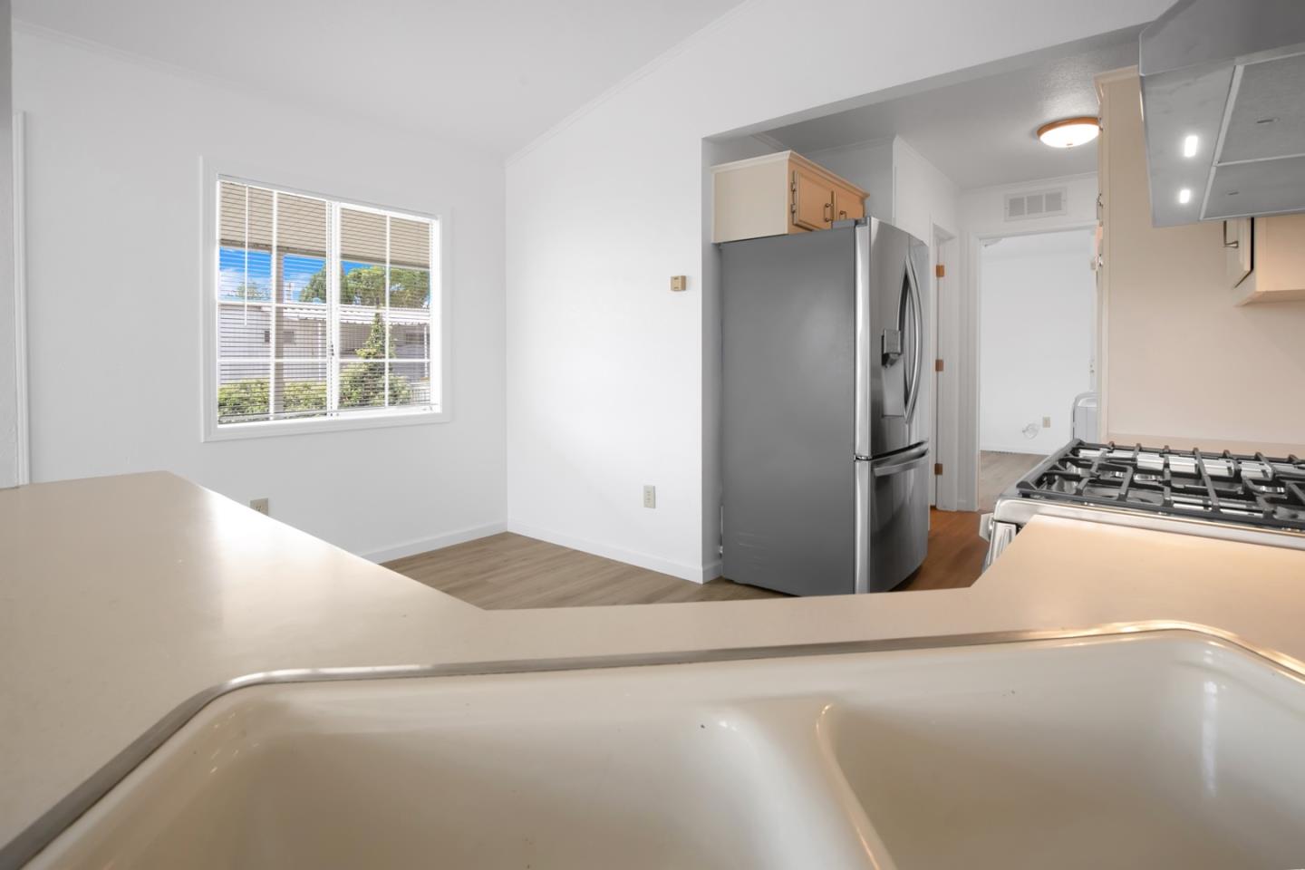 4300 Soquel Drive, Unit 15 Soquel, CA 95073 - Photo 8 of 15 a kitchen with a refrigerator and a stove top oven