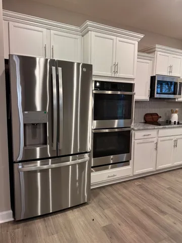 a kitchen with stainless steel appliances and wooden cabinets