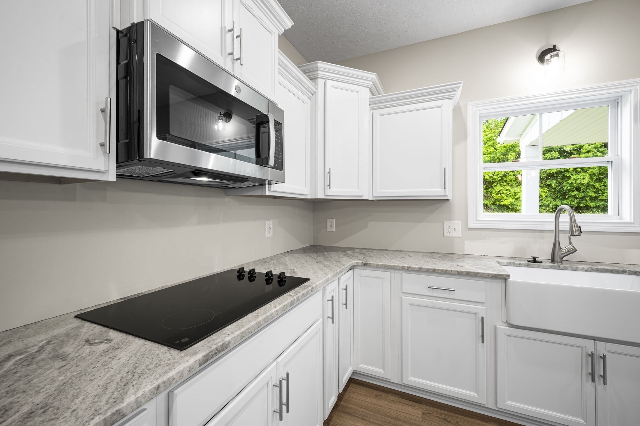 439 Blue Ridge Clarksville, TN 37043 - Photo 16 of 47 a kitchen with stainless steel appliances granite countertop a sink a microwave stove and white cabinets with wooden floor