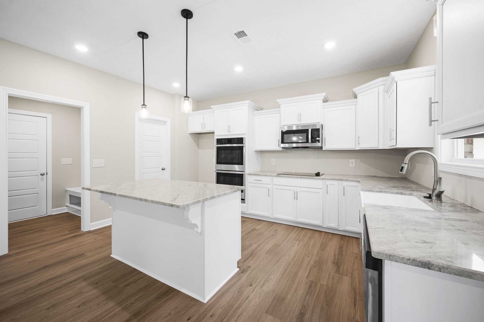 439 Blue Ridge Clarksville, TN 37043 - Photo 20 of 47 a kitchen with stainless steel appliances granite countertop a sink a stove a refrigerator and white cabinets with wooden floor