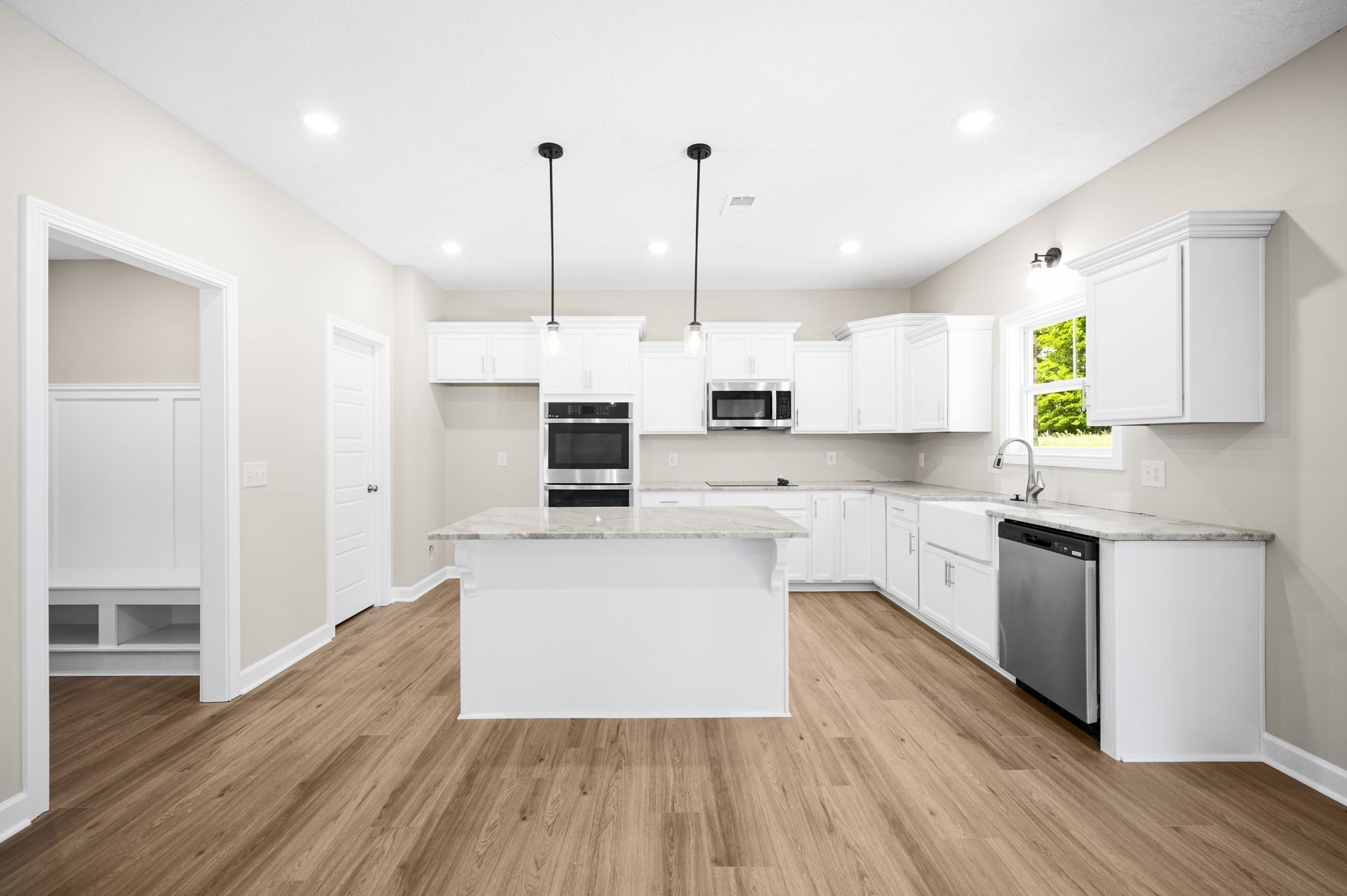 439 Blue Ridge Clarksville, TN 37043 - Photo 22 of 47 a kitchen with stainless steel appliances a refrigerator a sink dishwasher a stove and white cabinets with wooden floor