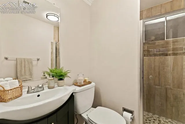 a bathroom with a sink toilet and shower