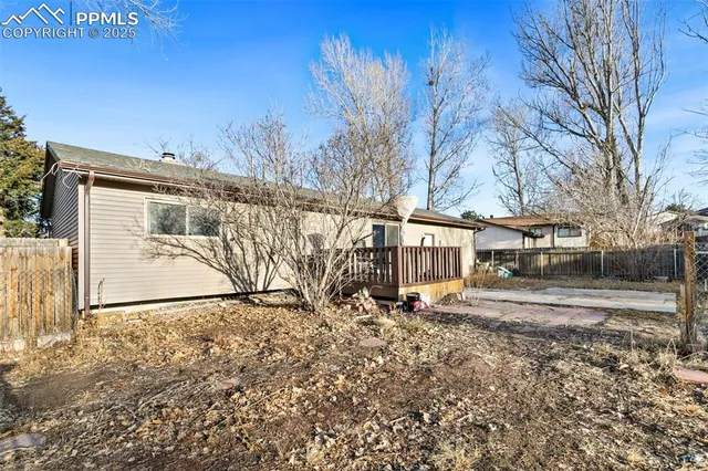 a big white house with a large trees