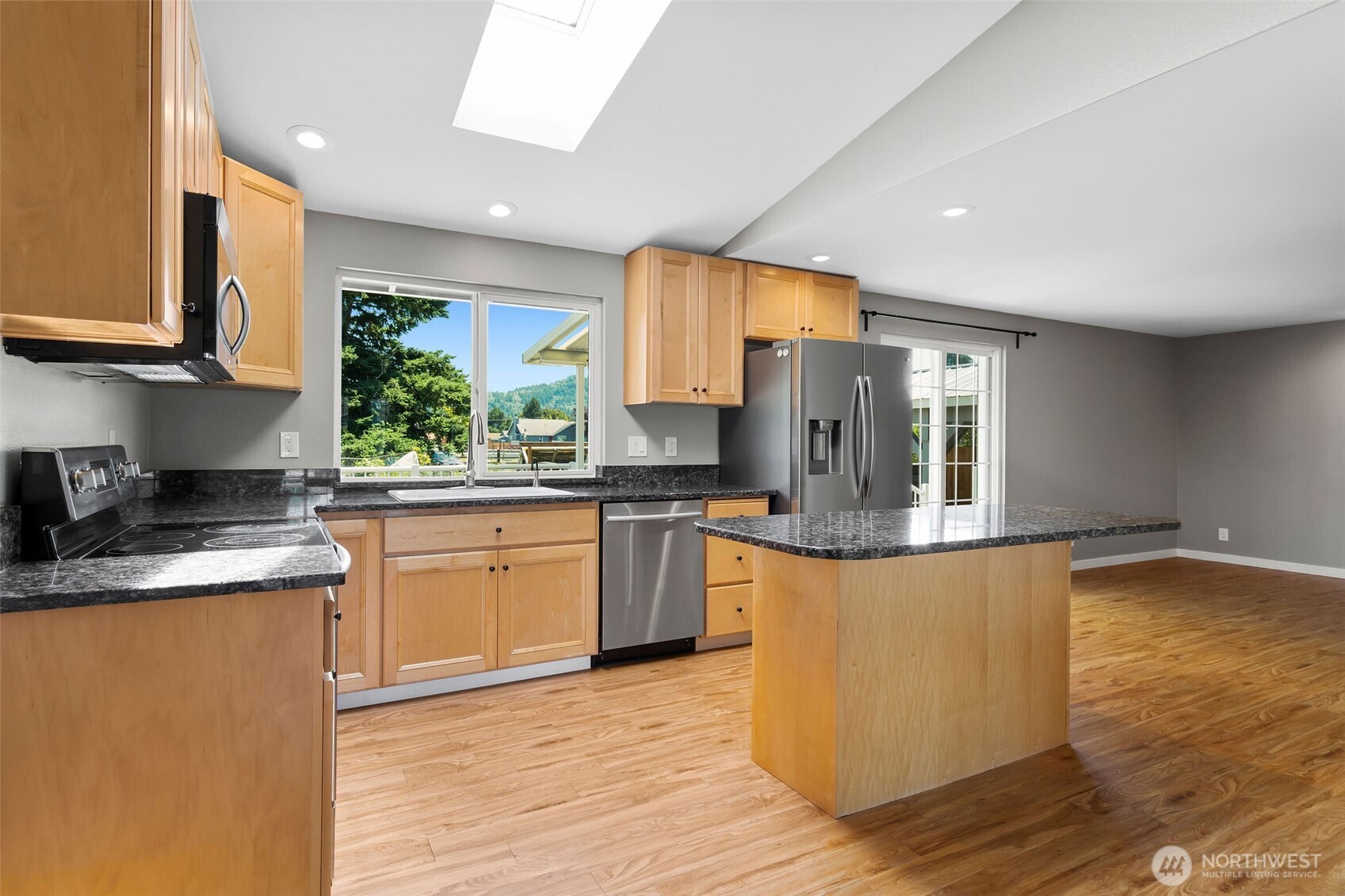201 Schmid Street Enumclaw, WA 98022 - Photo 12 of 40 a kitchen with stainless steel appliances granite countertop a sink a stove top oven a counter space and cabinets