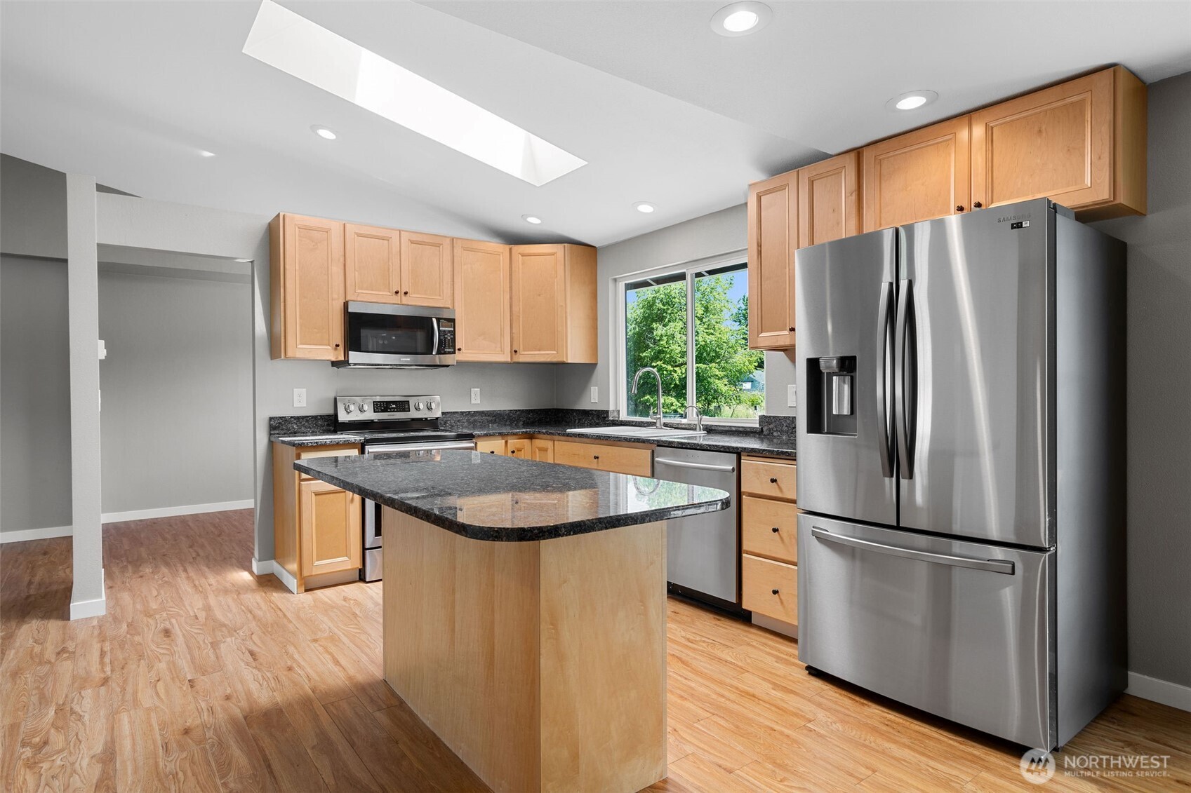 201 Schmid Street Enumclaw, WA 98022 - Photo 14 of 40 a kitchen with stainless steel appliances granite countertop a refrigerator stove and microwave