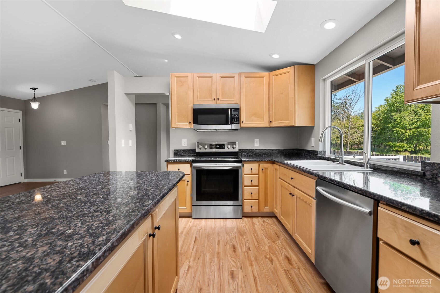 201 Schmid Street Enumclaw, WA 98022 - Photo 15 of 40 a kitchen with granite countertop a stove a sink and a refrigerator