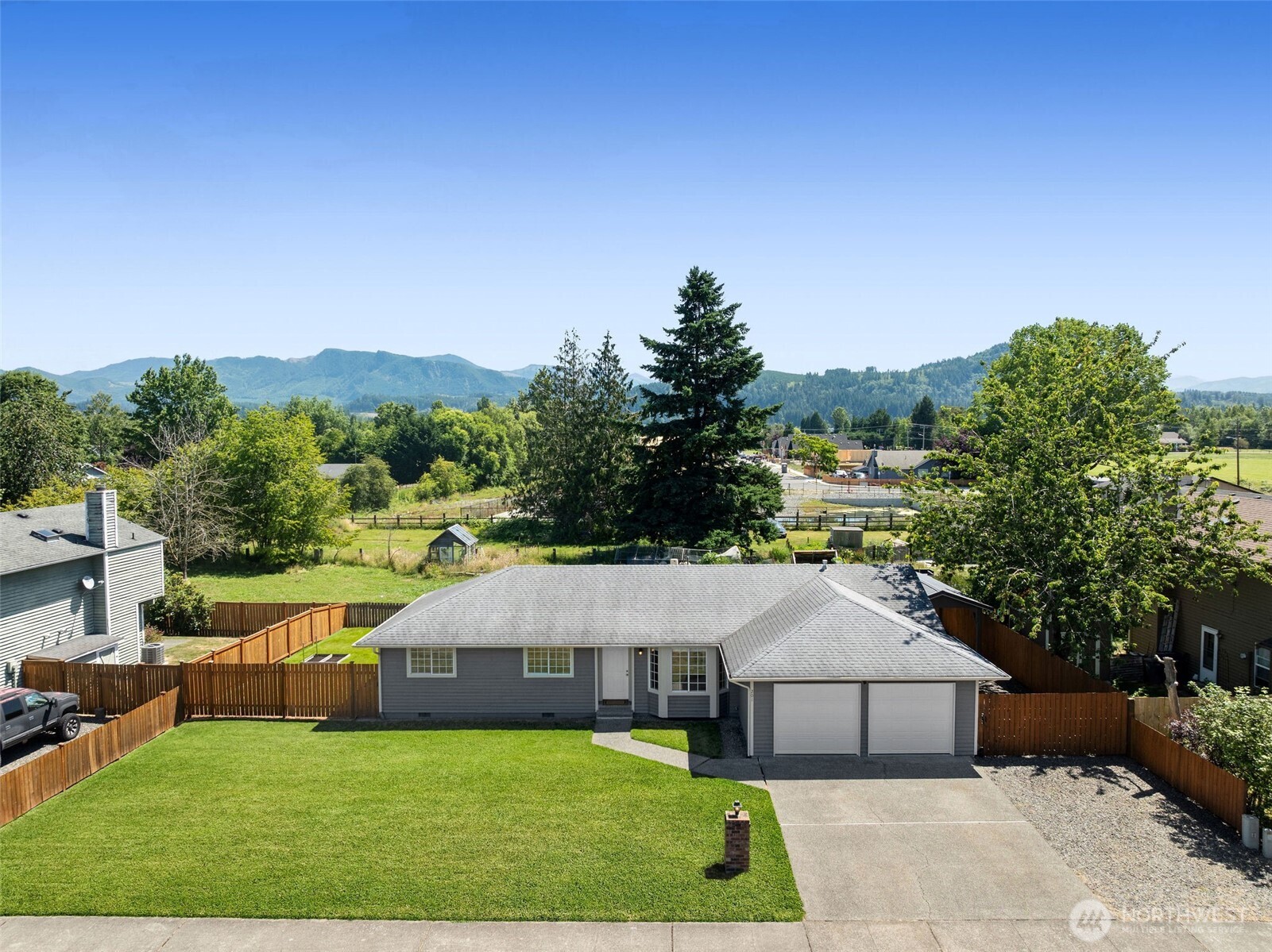 201 Schmid Street Enumclaw, WA 98022 - Photo 3 of 40 a aerial view of a house next to a big yard and large trees
