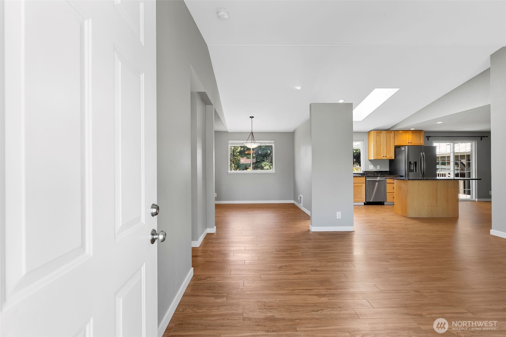 201 Schmid Street Enumclaw, WA 98022 - Photo 7 of 40 a view of a hallway with wooden floor and a kitchen