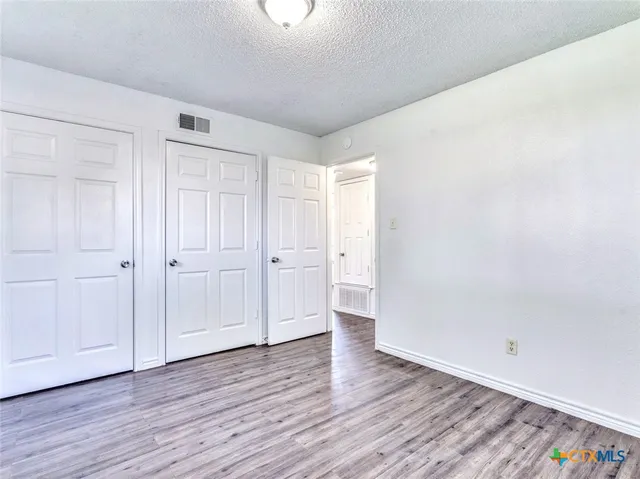a view of an empty room and wooden floor