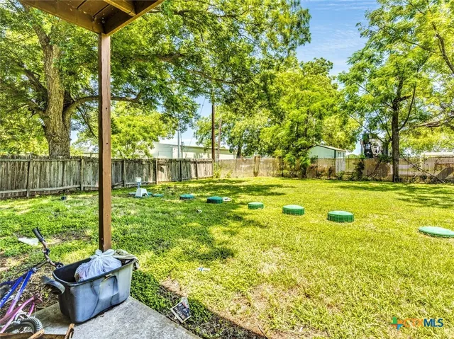 a view of a house with a yard and sitting area